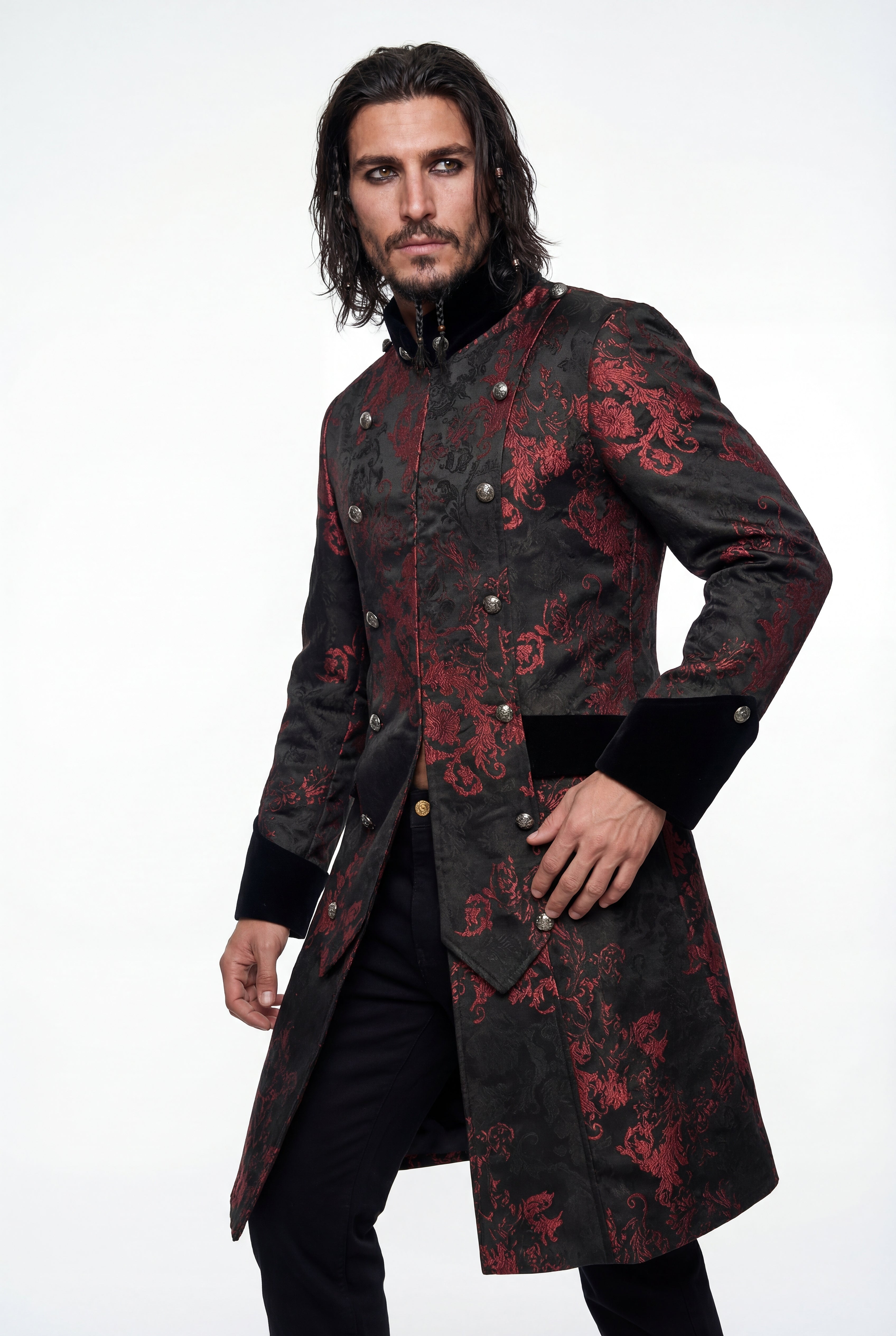 Man wearing a black coat with red floral patterns on a white background