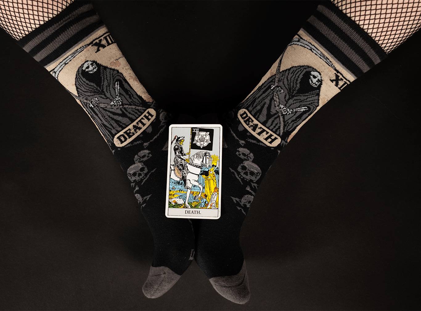 Death Tarot Card Crew Socks featuring a grim reaper design and a tarot card on a black background.