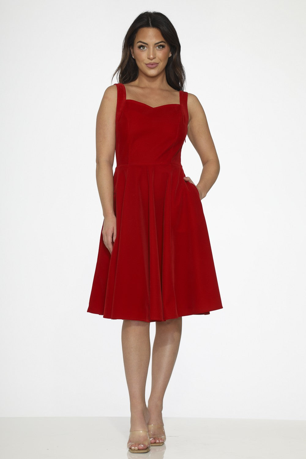 Red velvet swing dress with pockets, featuring wide straps and a full skirt, perfect for any occasion.