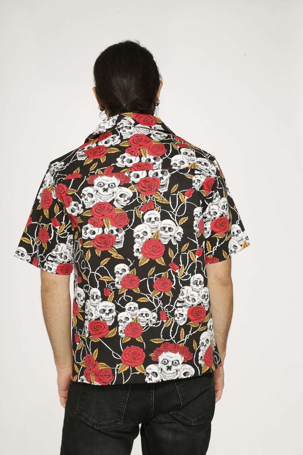 Skull & Roses Black Shirt - Orchid Bloom worn from the back, featuring a bold skull-and-rose pattern.