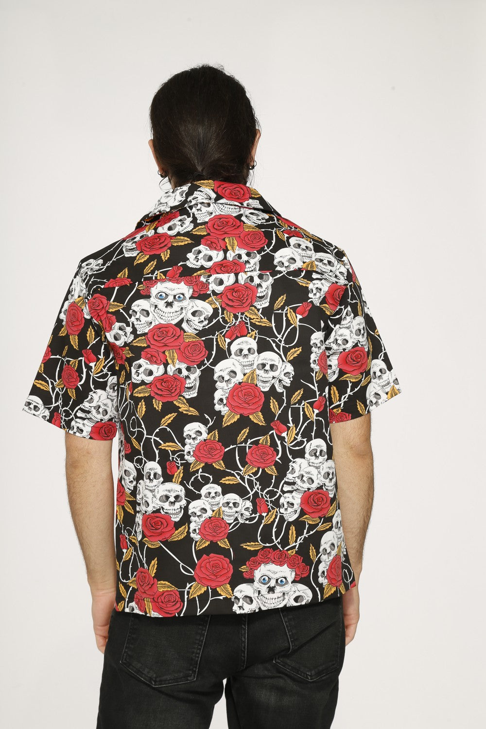 Skull & Roses Black Shirt - Orchid Bloom worn from the back, featuring a bold skull-and-rose pattern.