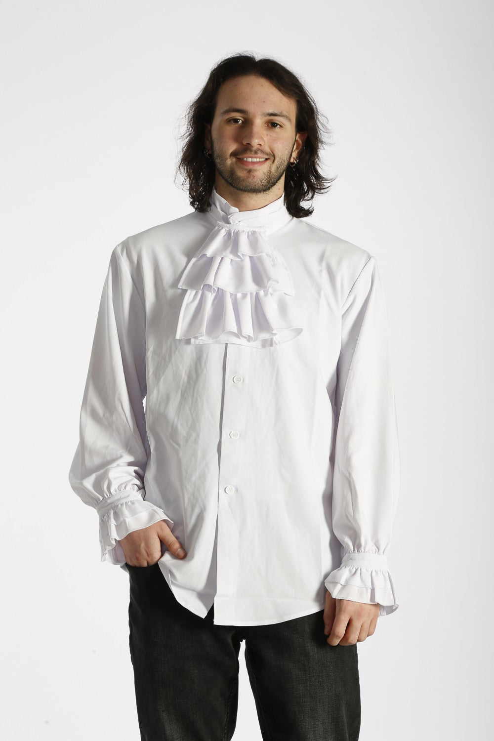 Man wearing a white ruffled shirt against a white background