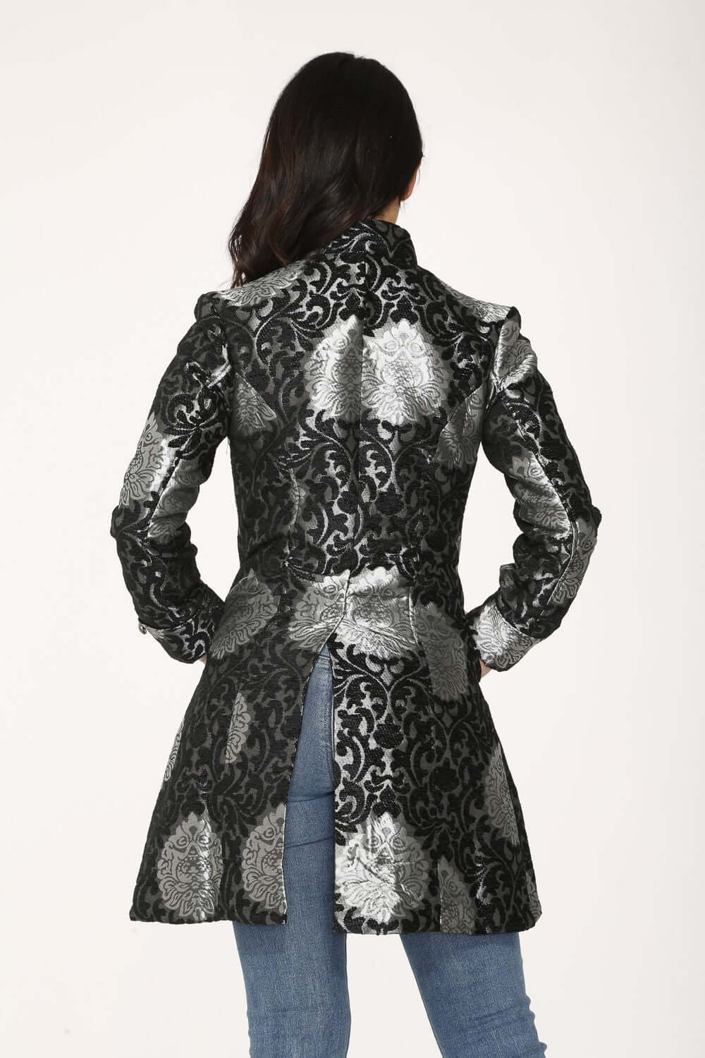 Back view of a stylish silver brocade women's coat featuring a metallic damask pattern and elegant tailoring.