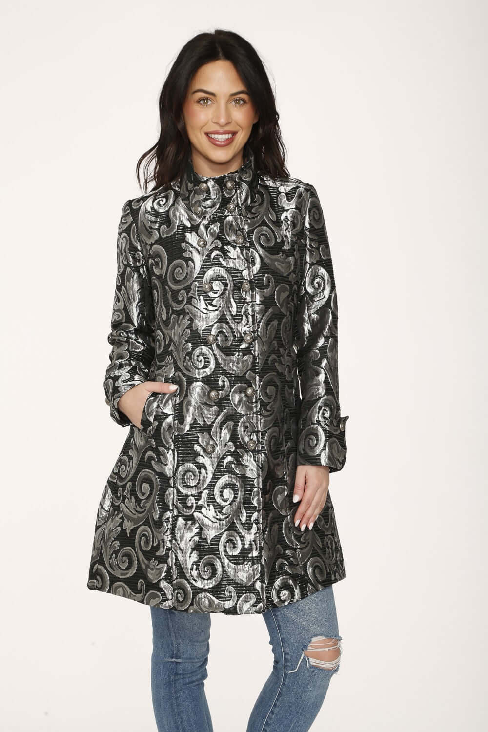 Stylish woman wearing a silver brocade women's coat with a high collar and double buttons, showcasing a metallic scroll pattern.