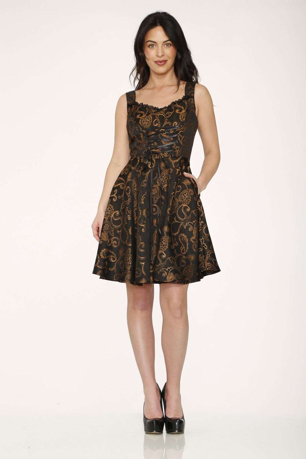 Woman wearing a black & gold  dress on a white background