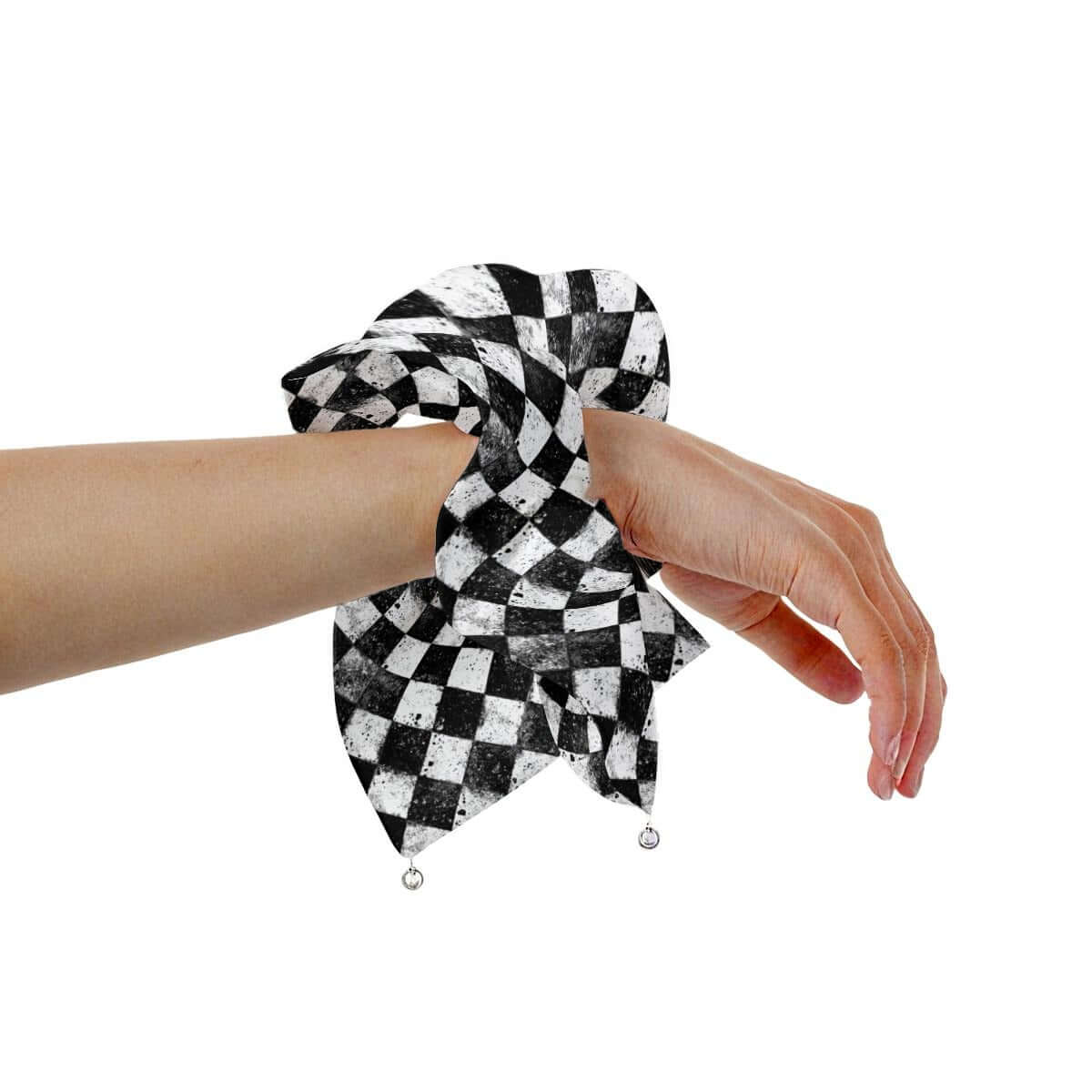 CARNYVL Dirty Diamonds Pearl Hair Tie Scrunchie on a hand showcasing a black and white checkered design.