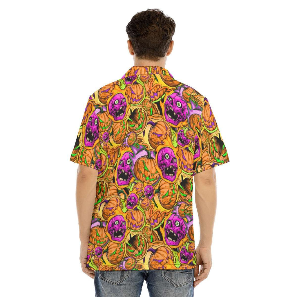 Person wearing a colorful Halloween-themed shirt with pumpkins and ghosts on a white background