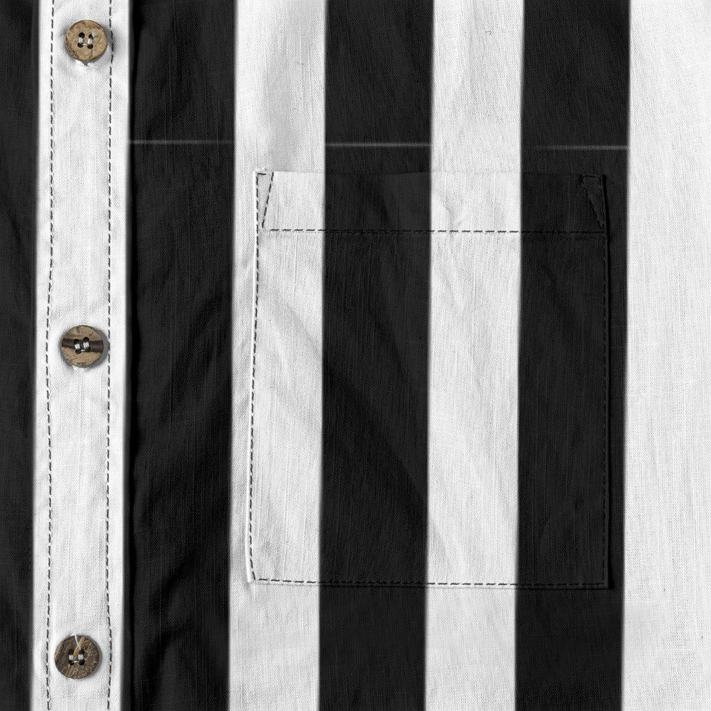 Close-up of the Ringmaster’s black and white striped button-up shirt featuring buttons and a chest pocket.
