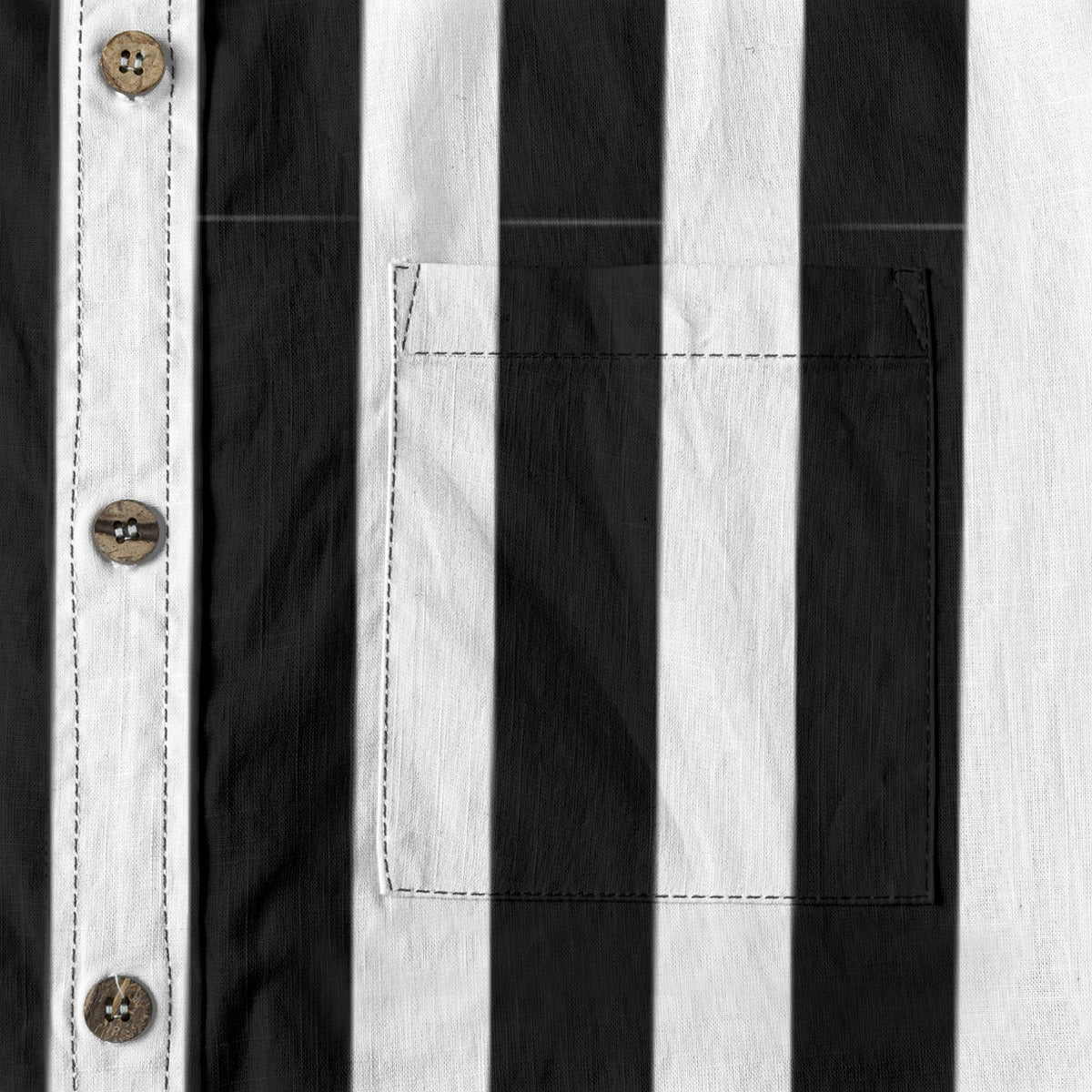 Close-up of the Ringmaster’s black and white striped button-up shirt featuring buttons and a chest pocket.