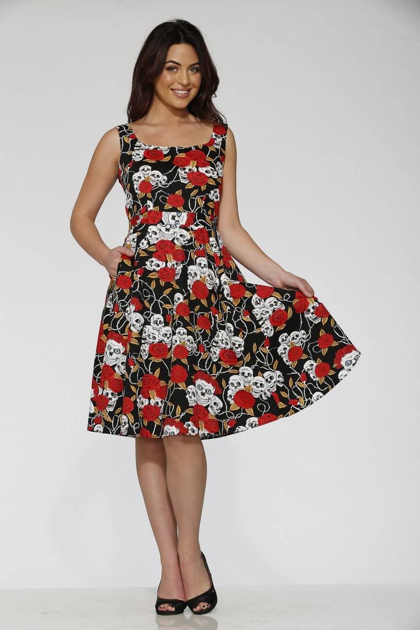 Gothic dress featuring vivid red roses and white skulls on a black background in a fit-and-flare style.