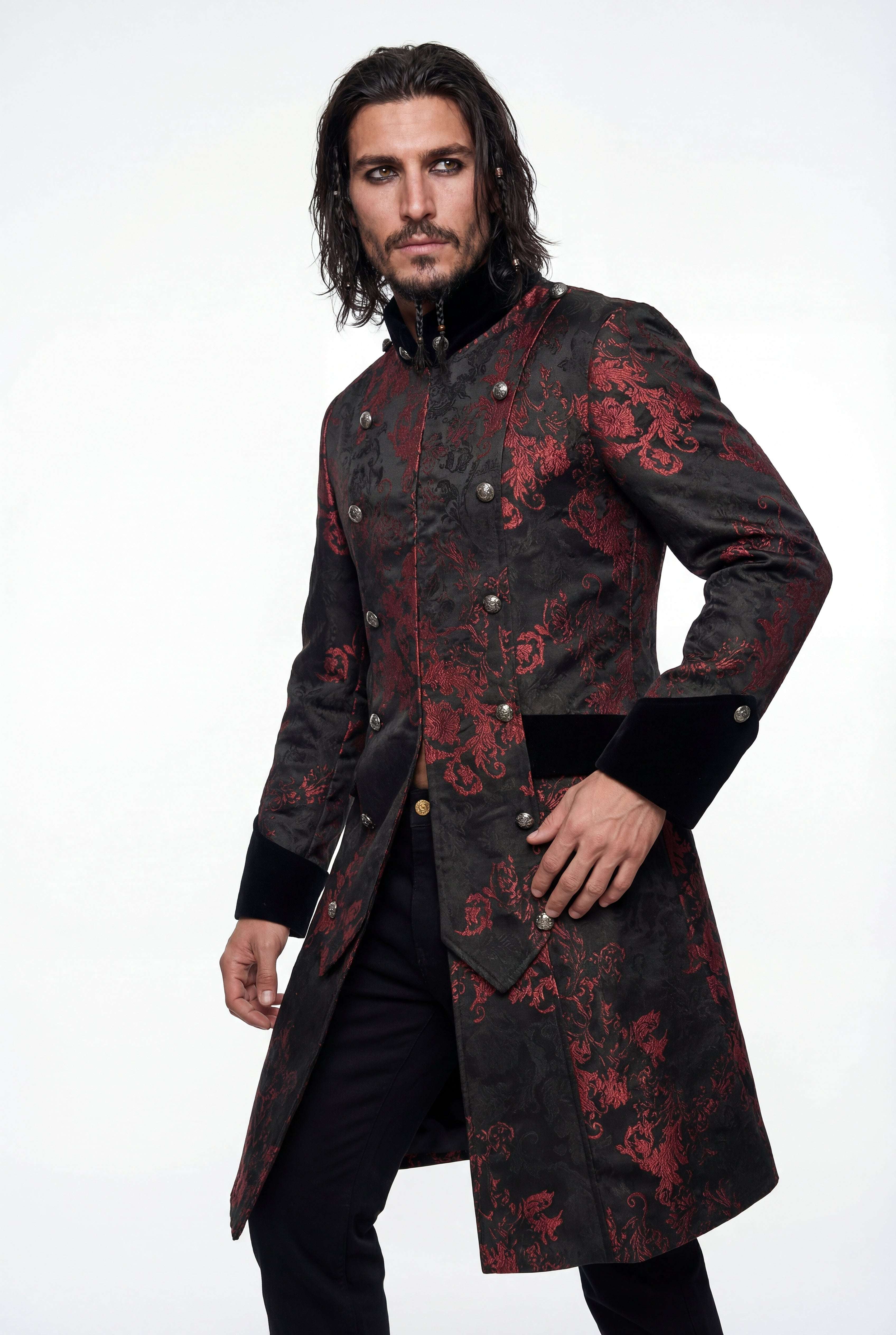 Man wearing a black coat with red floral patterns on a white background