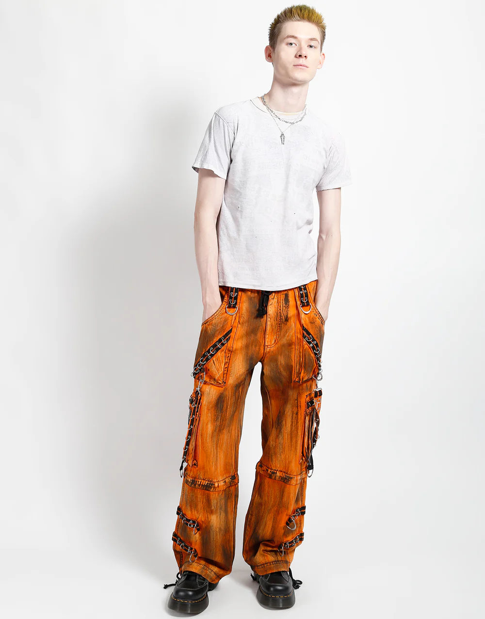 TRIPP NYC MIGHTY METAL PANT ORANGE INK WASH GOTHIC STREETWEAR styled with a gray shirt, showcasing a bold look.