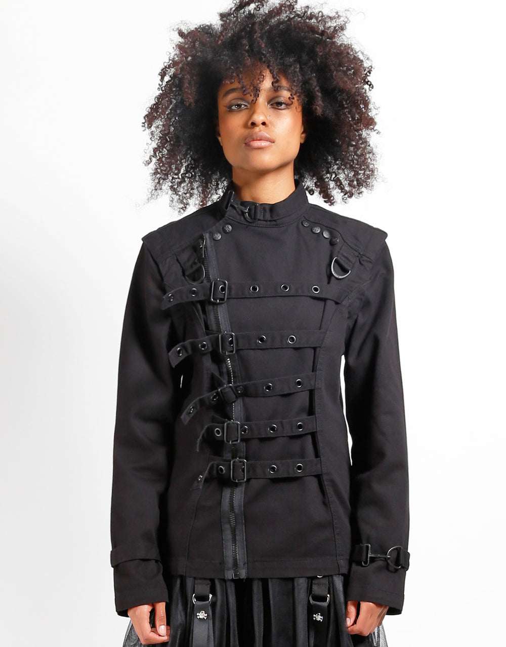 Model wearing TRIPP Zip Off Buckle Jacket featuring buckles and adjustable wrist straps.