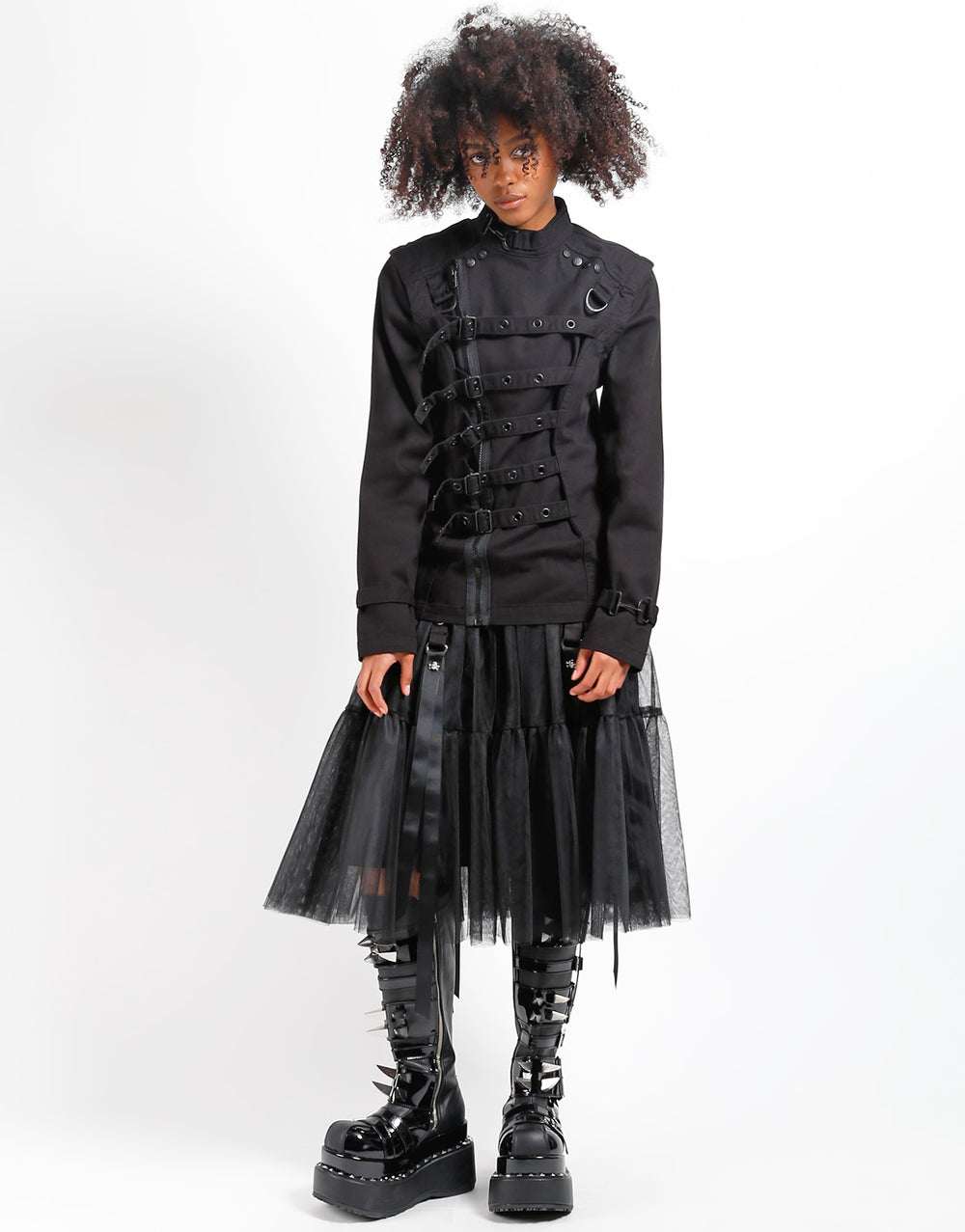 Model wearing TRIPP Zip Off Buckle Jacket with a layered tulle skirt and chunky boots, showcasing a bold fashion statement.