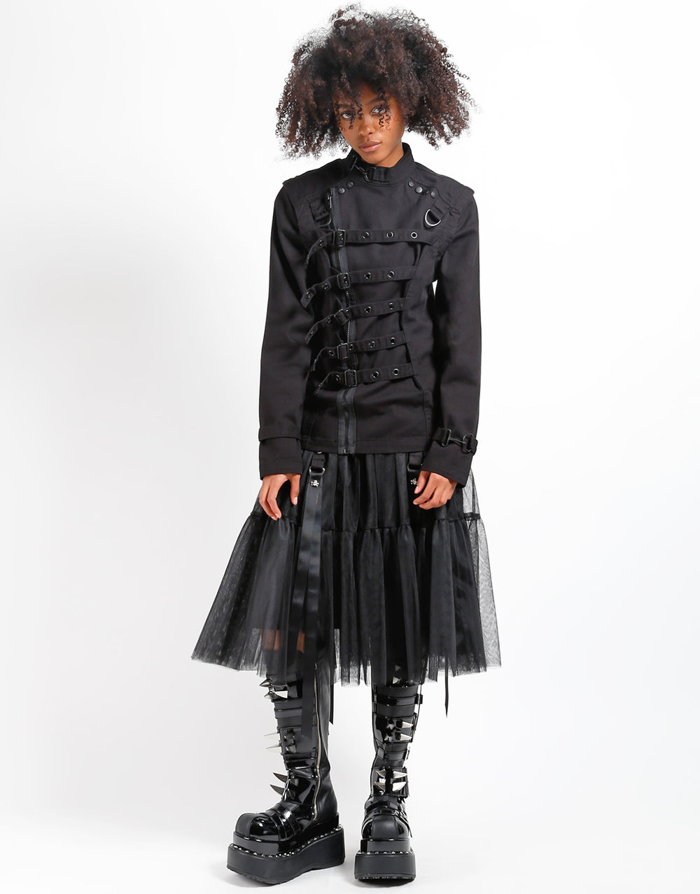 Model wearing TRIPP Zip Off Buckle Jacket with a layered tulle skirt and chunky boots, showcasing a bold fashion statement.