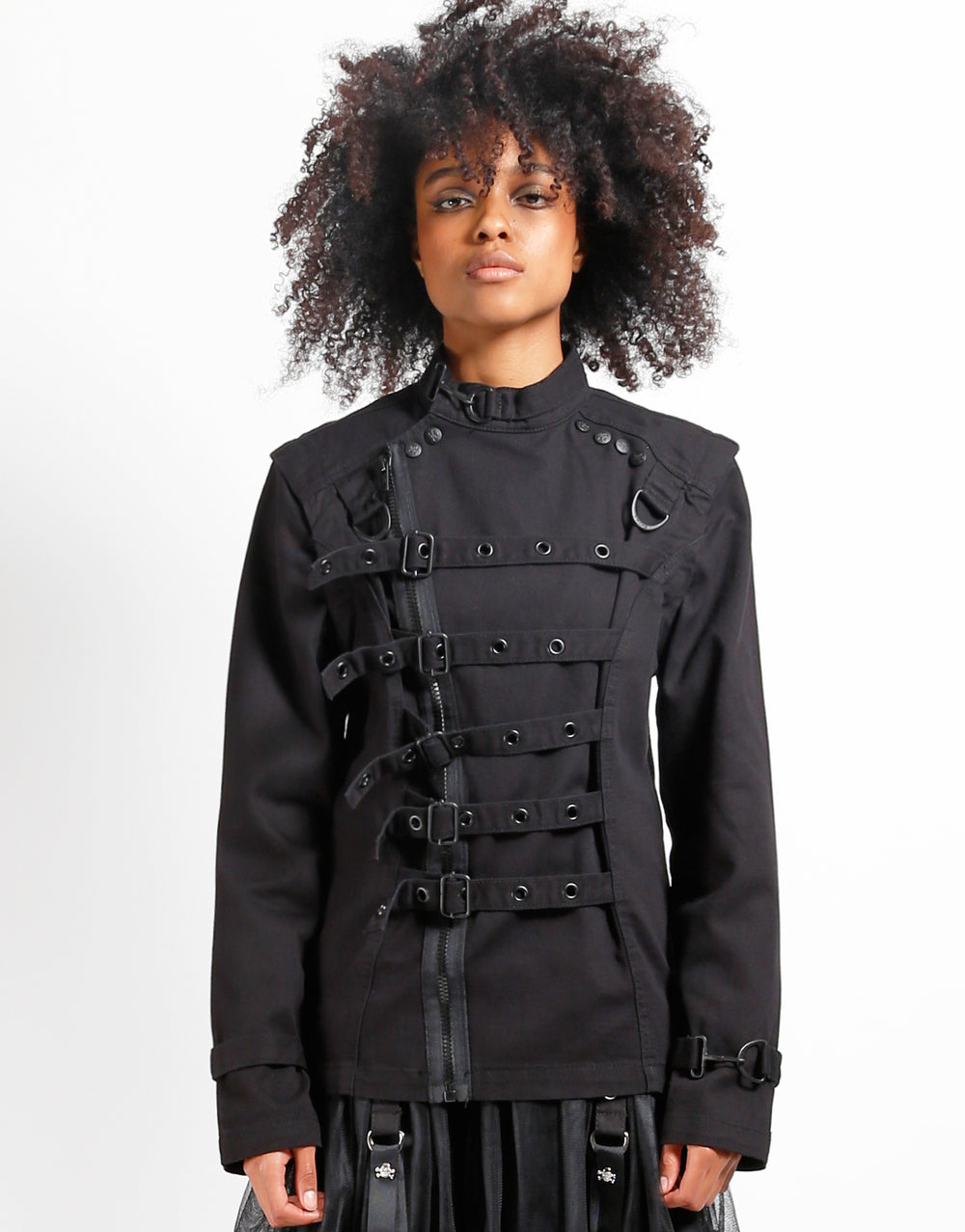 Model wearing TRIPP Zip Off Buckle Jacket featuring buckles and adjustable wrist straps.