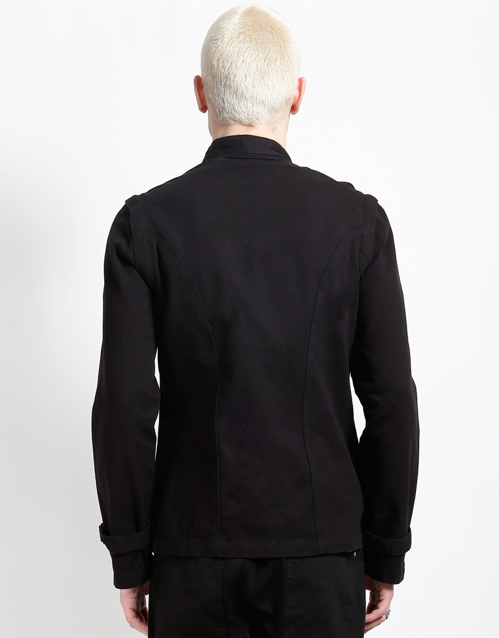 Back view of a model wearing the TRIPP zip off buckle jacket in black.