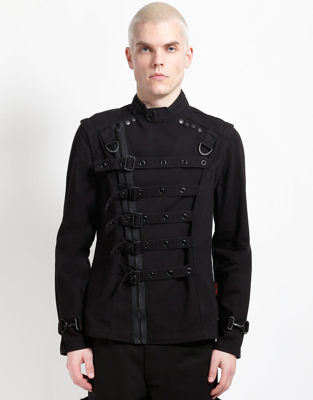 Male model wearing TRIPP Zip Off Buckle Jacket with adjustable buckles and zippered details.