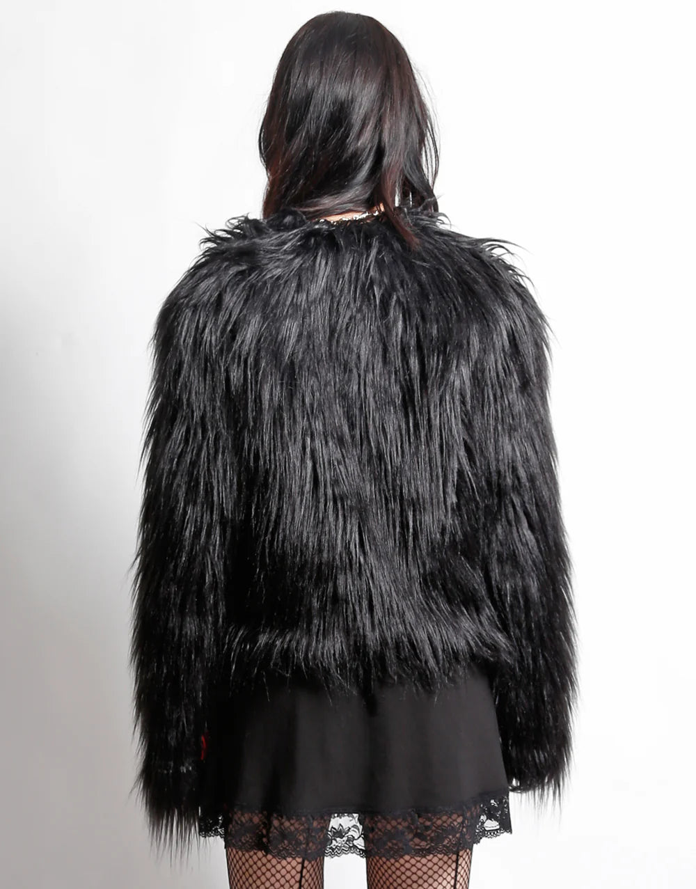 Back view of TRIPP NYC faux fur jacket for stylish outings, showcasing its bold texture and cropped design.