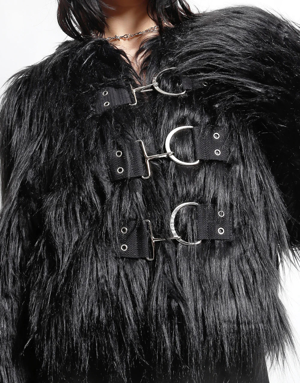 Close-up of TRIPP NYC faux fur jacket for stylish outings with industrial metal clasps, showcasing its bold texture and dramatic design.