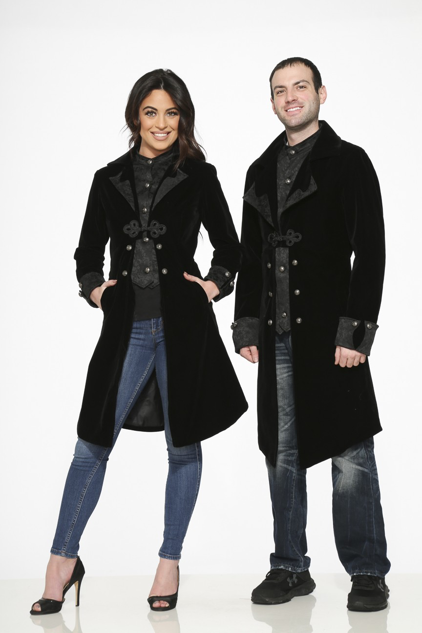 Victorian inspired velvet coat worn by a man and a woman, showcasing a stylish black velvet design with braided frog closure.