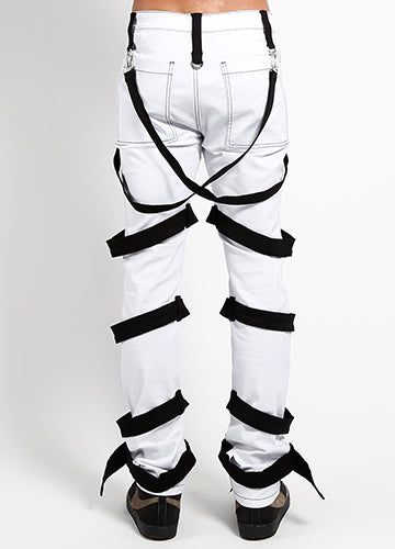 Back view of Tripp NYC white bondage pants with harness, featuring black straps and D-rings for a bold look.