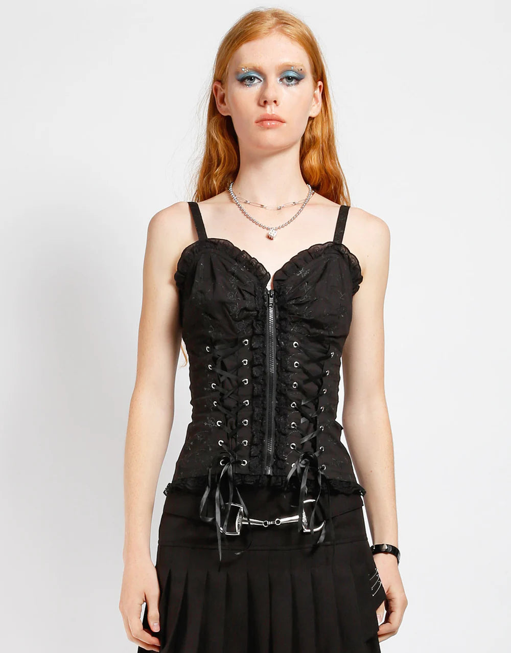 Tripp NYC Skull Corset Top – Gothic Punk Skull Embroidery Shirt displayed by model with intricate lace and skull details.
