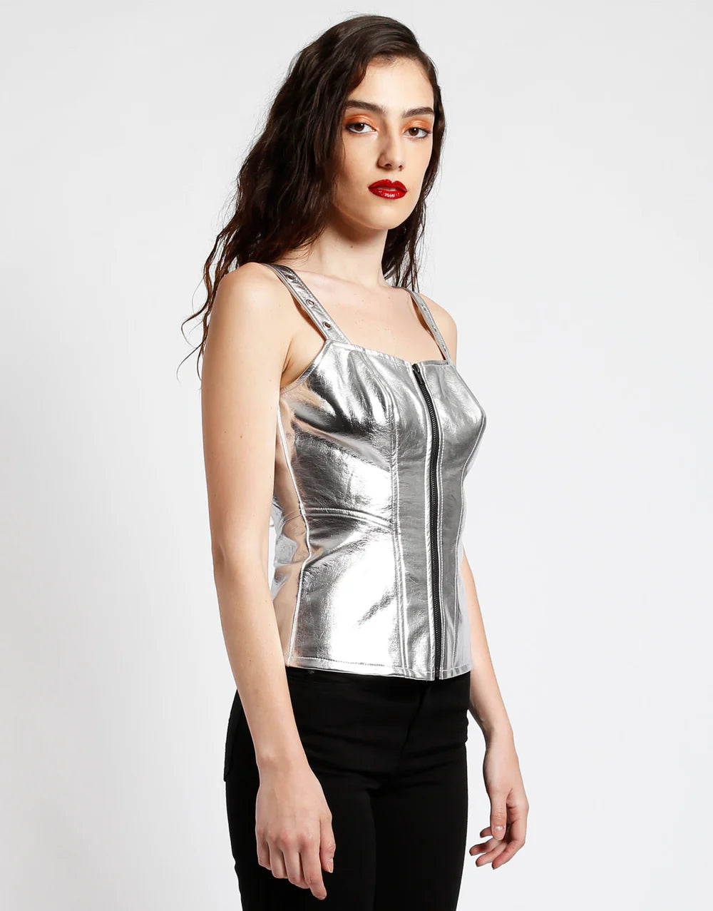 Tripp NYC silver metallic faux leather corset top with zip front, showcasing a sleek design and structured silhouette.