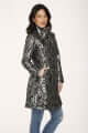 Model wearing a silver brocade women's coat with high collar and double buttons, styled with jeans.