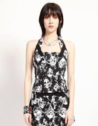 Tripp NYC Mary Chain Shadow Skill Pleated Skirt model wearing a skull print halter top with chains